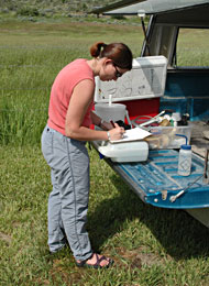 Christine Waite records field notes during monthly chemistry sampling.